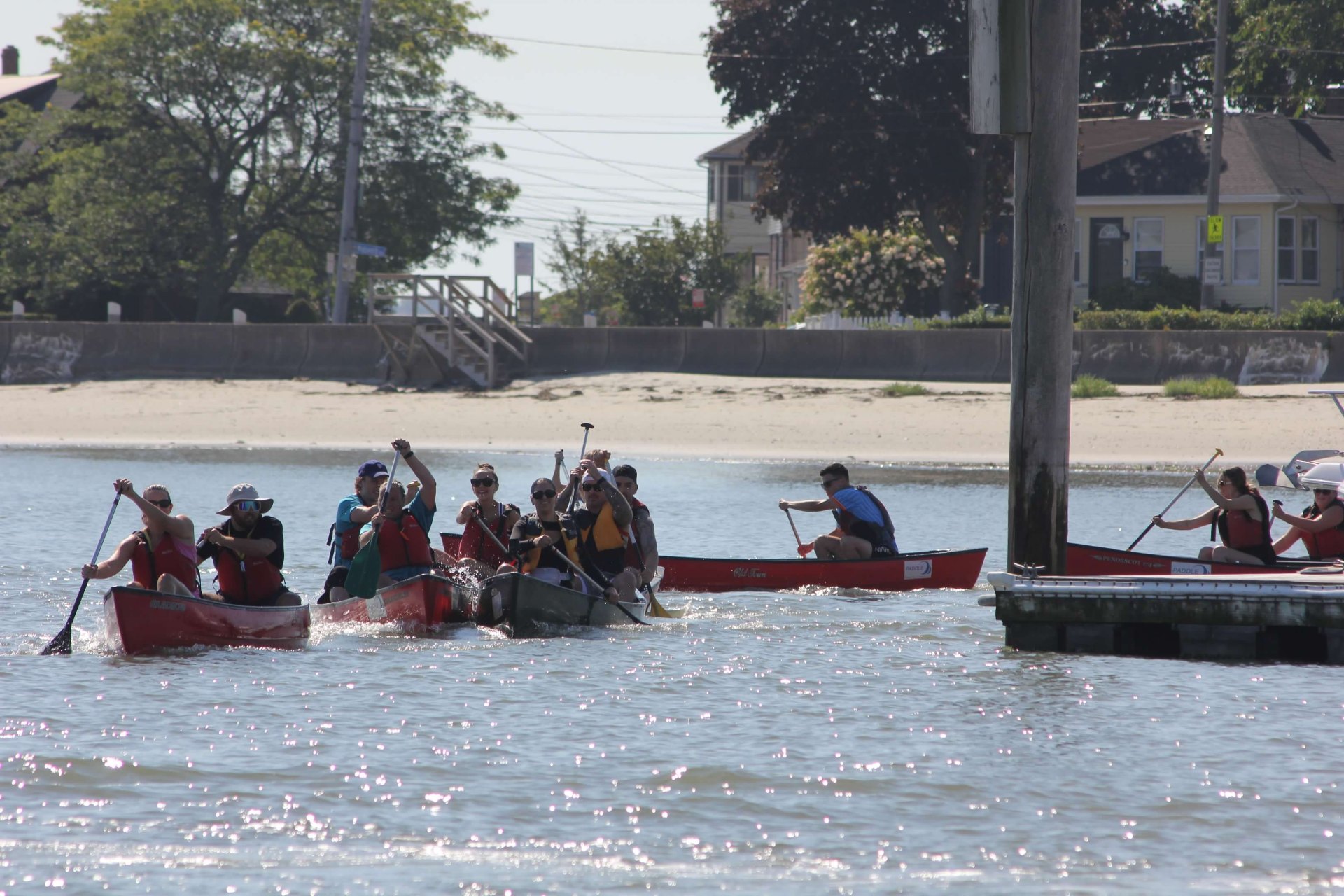 Canoe teams launching from the beach at Point of Pines