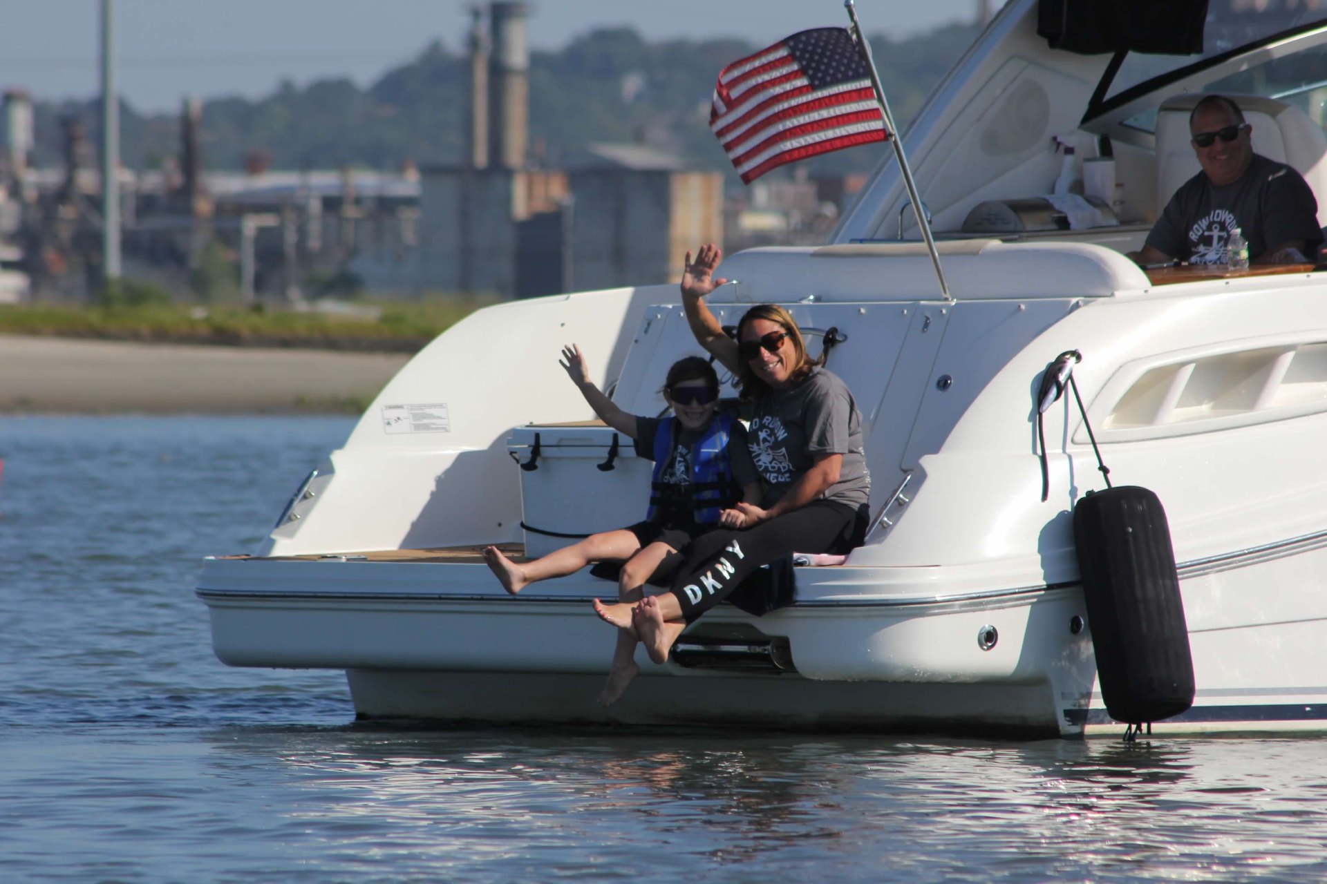 Family cheering from a spectator boat